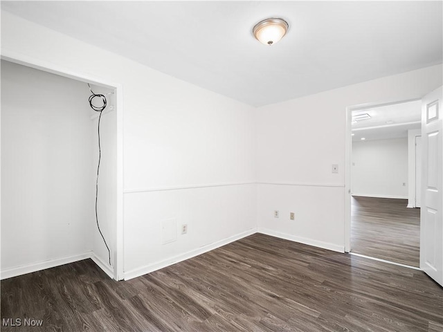 unfurnished room featuring wood finished floors and baseboards