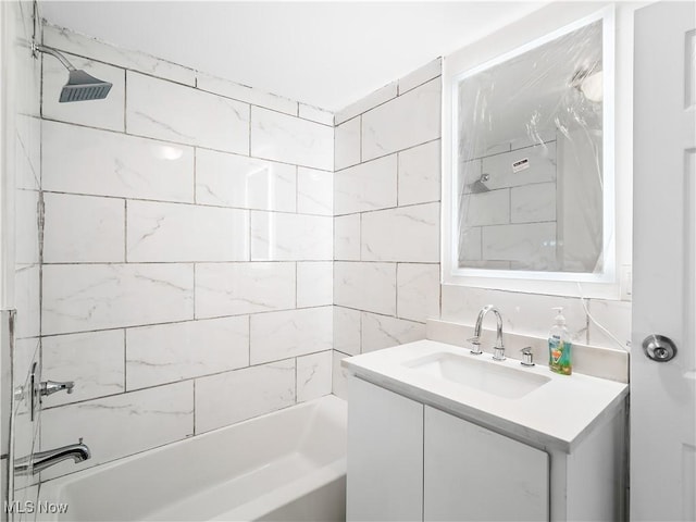 bathroom with washtub / shower combination and vanity