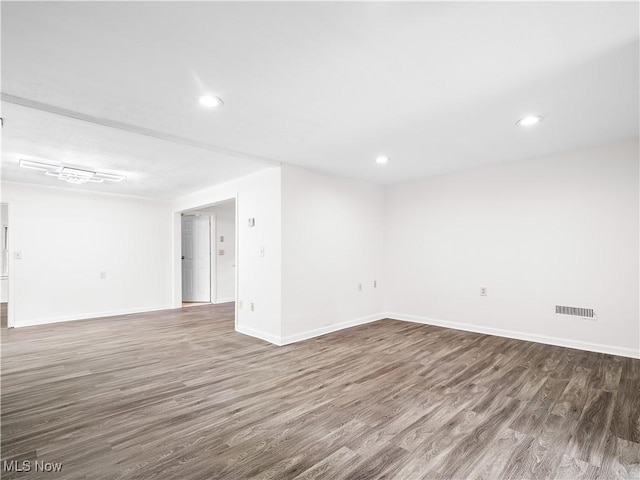 spare room with recessed lighting, visible vents, baseboards, and wood finished floors