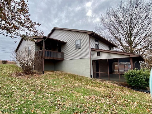 back of house with a sunroom and a yard