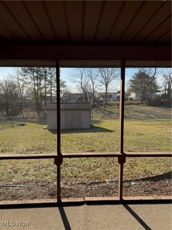 view of yard featuring a storage unit and an outbuilding