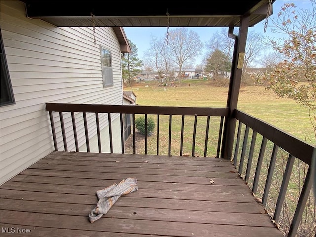 wooden terrace featuring a yard