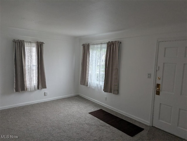 entryway featuring carpet and baseboards