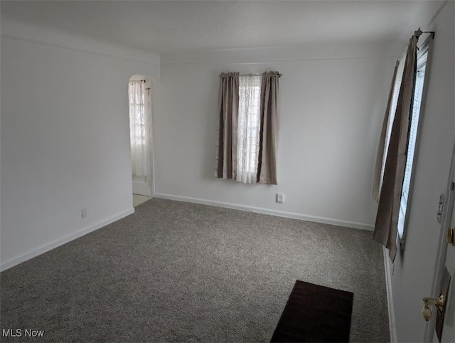 carpeted spare room with baseboards