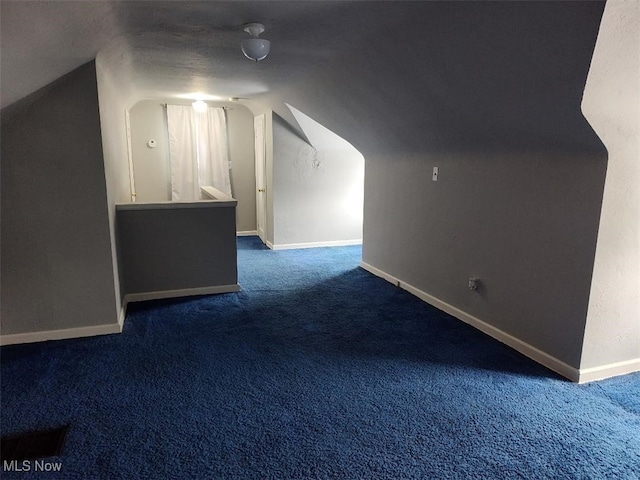 bonus room with carpet, lofted ceiling, and baseboards