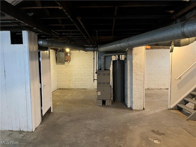 unfinished basement with water heater, stairs, and electric panel