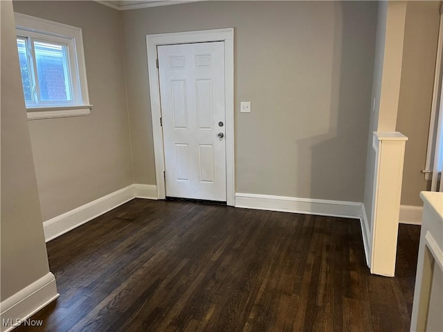 interior space featuring dark wood-style floors and baseboards