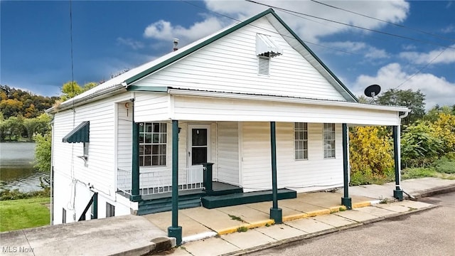 view of front facade featuring covered porch and a water view