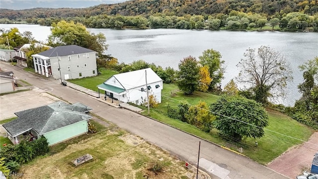 aerial view with a water view and a wooded view