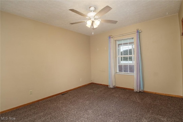 spare room featuring carpet floors, ceiling fan, baseboards, and a textured ceiling