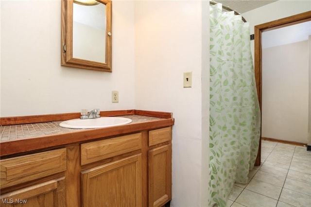 full bath featuring tile patterned flooring, vanity, and a shower with shower curtain