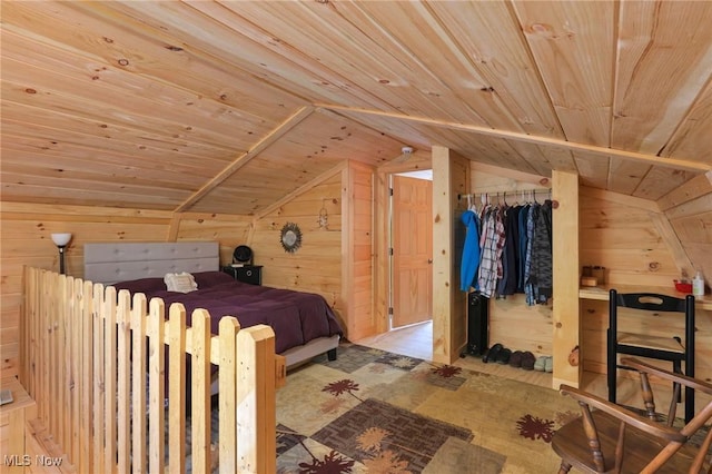 bedroom with lofted ceiling, wooden ceiling, and wooden walls