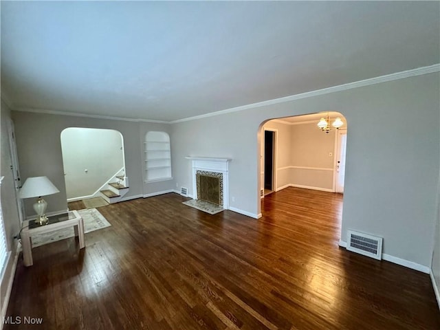 unfurnished living room featuring arched walkways, stairs, a fireplace with flush hearth, and visible vents