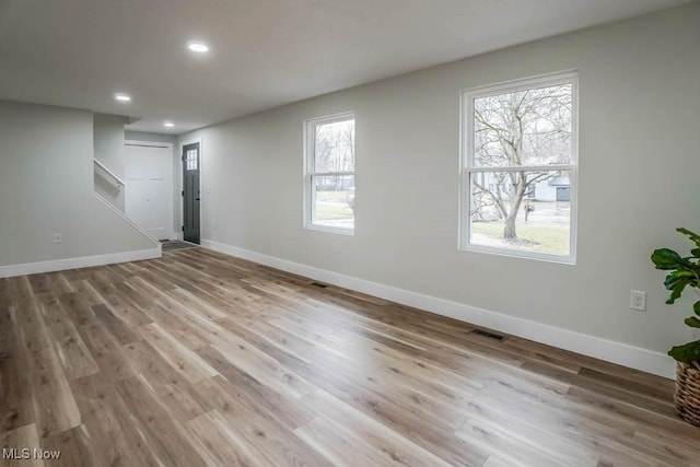 interior space with recessed lighting, wood finished floors, visible vents, and baseboards