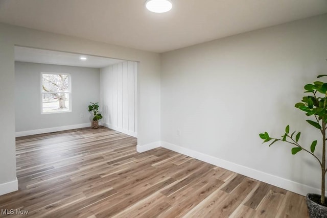 empty room featuring light wood-style floors and baseboards