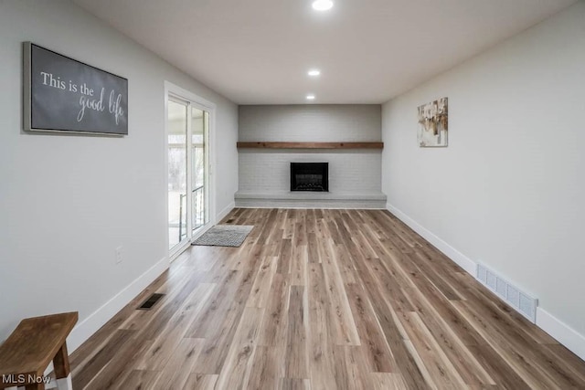 unfurnished living room featuring visible vents and baseboards