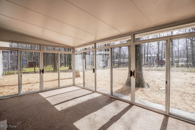 unfurnished sunroom with plenty of natural light and vaulted ceiling