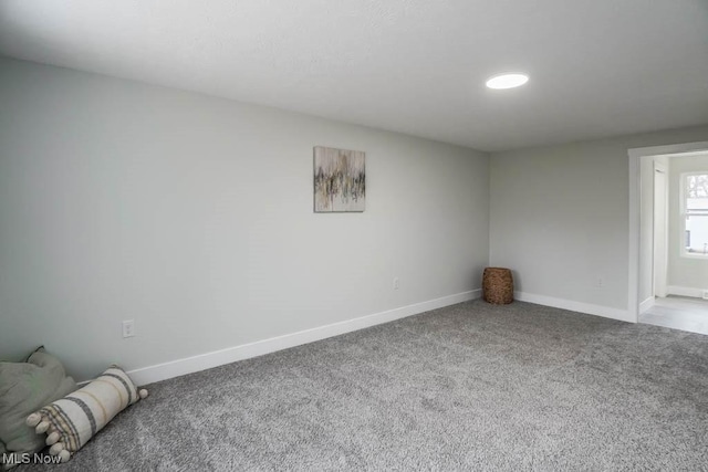 spare room with carpet flooring and baseboards