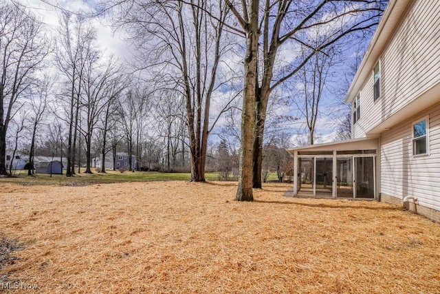 view of yard featuring a sunroom