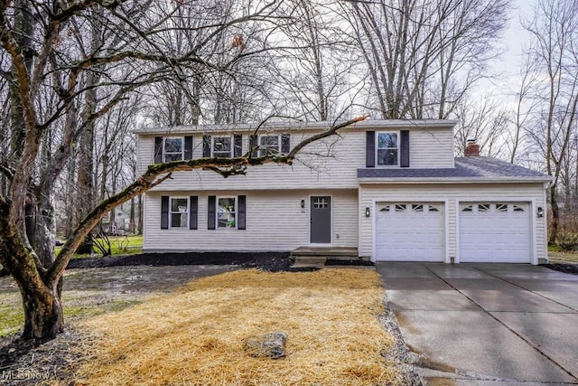 view of front facade with driveway and a chimney