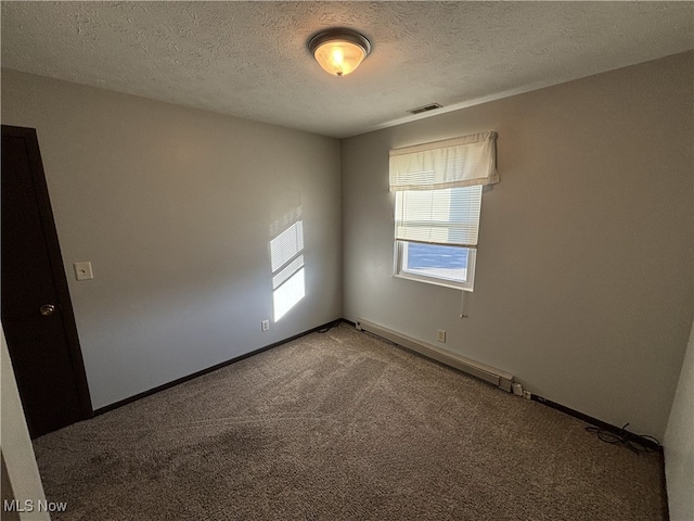 unfurnished room with baseboards, carpet flooring, visible vents, and a textured ceiling