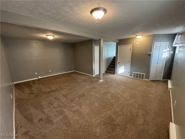 finished below grade area featuring a baseboard radiator, visible vents, carpet, and stairs