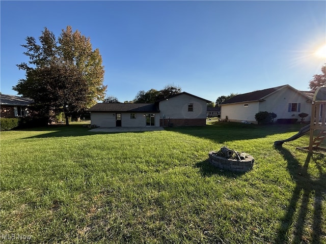 view of yard with a fire pit and a patio