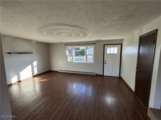 entrance foyer with a textured ceiling, baseboards, baseboard heating, and dark wood-type flooring