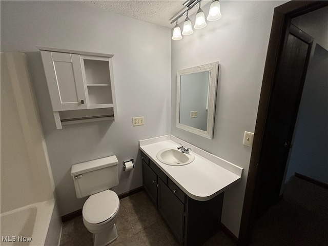 bathroom with baseboards, toilet, tile patterned floors, a textured ceiling, and vanity