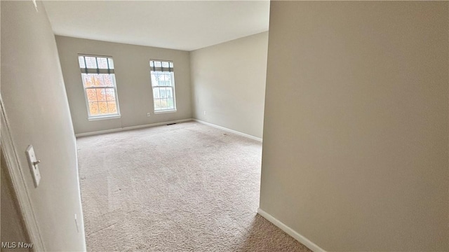 empty room with carpet flooring and baseboards