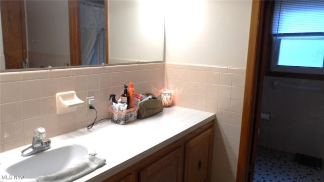 full bath with tile walls and vanity