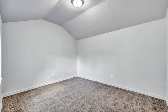 bonus room featuring lofted ceiling, carpet, and baseboards