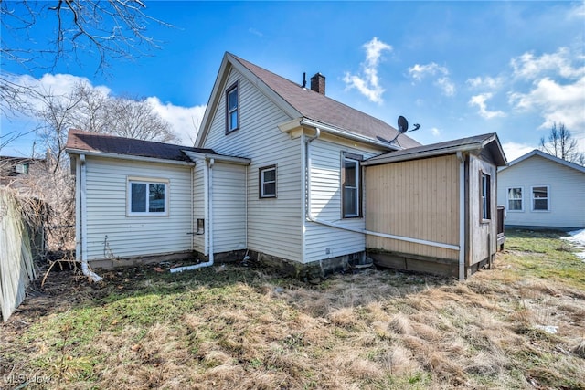 rear view of property with fence