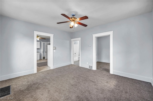 unfurnished bedroom with ceiling fan, carpet flooring, visible vents, and baseboards