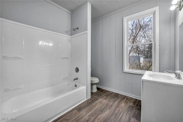 bathroom with shower / washtub combination, vanity, toilet, and wood finished floors