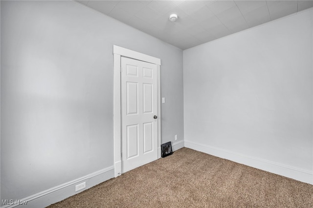 carpeted empty room with baseboards