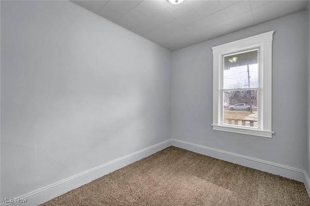 carpeted spare room with baseboards