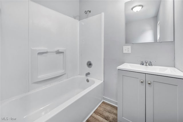 full bathroom with shower / washtub combination, wood finished floors, and vanity