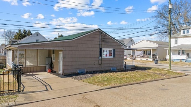 view of front of house with a carport and fence