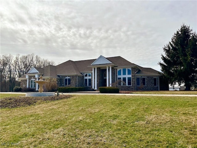 greek revival house featuring a front yard