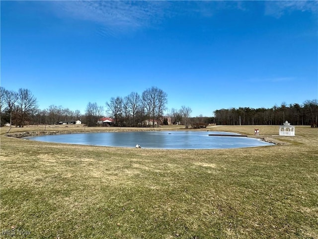 exterior space featuring a water view and a lawn