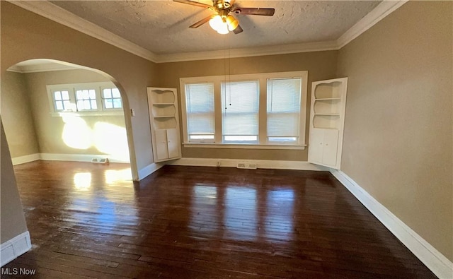 unfurnished room with ornamental molding, arched walkways, visible vents, and hardwood / wood-style floors