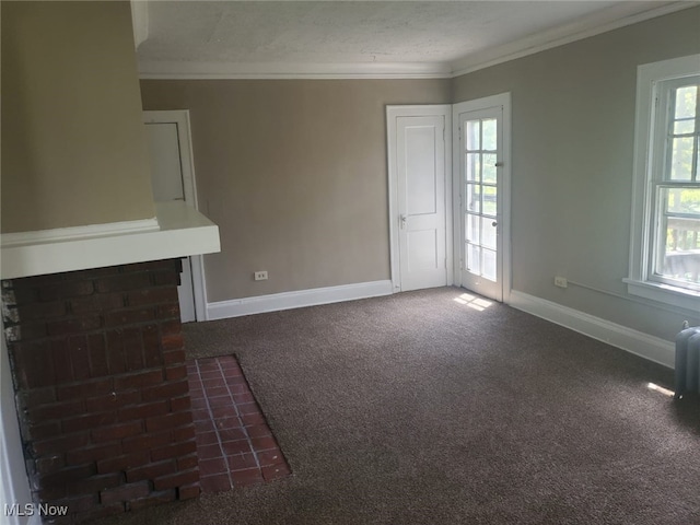 unfurnished living room with carpet floors, crown molding, and baseboards