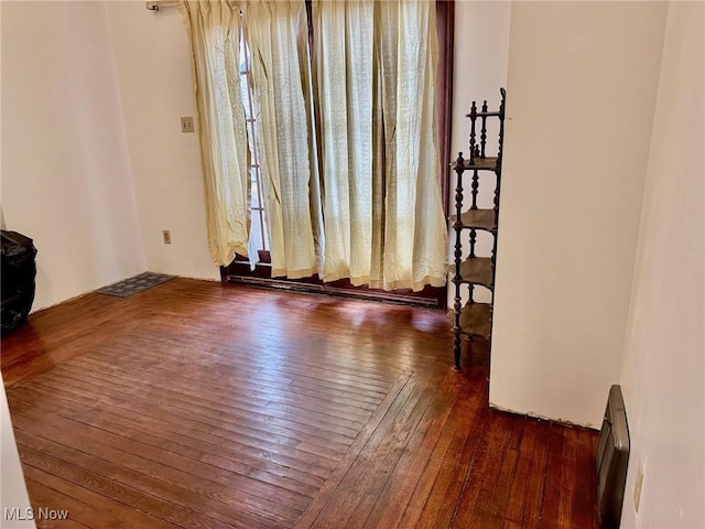 unfurnished room with hardwood / wood-style floors