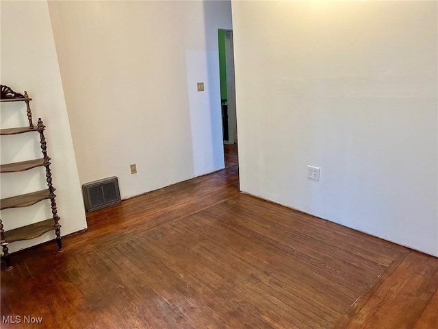 spare room featuring visible vents and hardwood / wood-style flooring