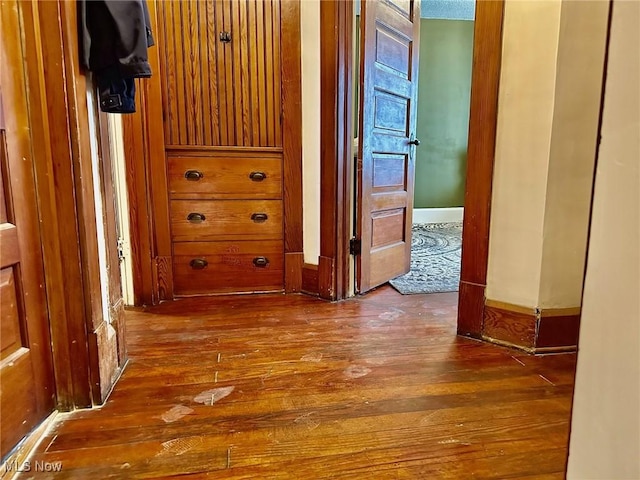 hallway with hardwood / wood-style floors