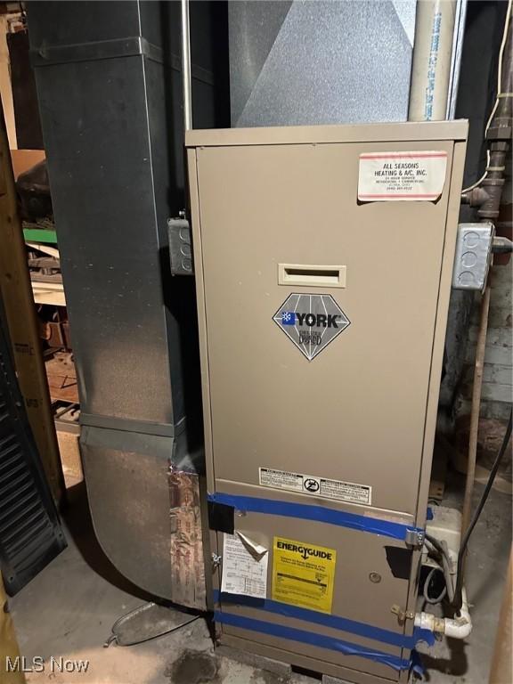 utility room featuring heating unit