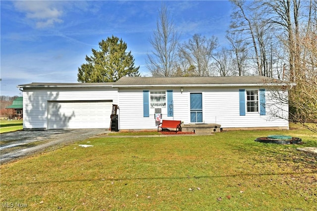 view of front of house with a front lawn, driveway, and an attached garage