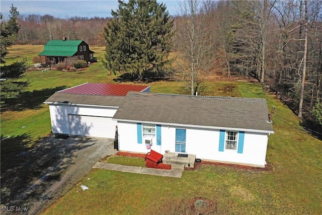 view of front of property featuring a garage and a front lawn