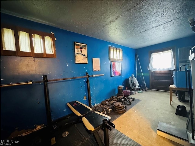 workout area featuring a textured ceiling